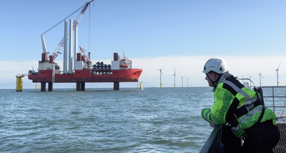 Worker overlooking offshore wind farm