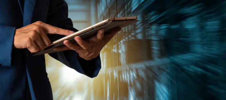 A man with a tablet in a data centre