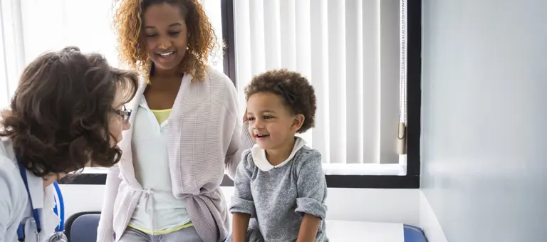 doctor attending to child and parent