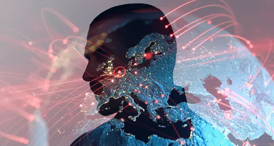 The silhouette of a man's head superimposed over the Earth lit up at night