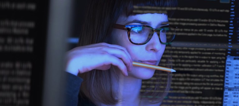 Woman looking at screens with data