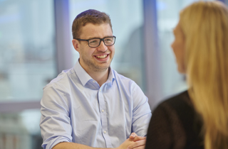 Two colleagues chatting and smiling