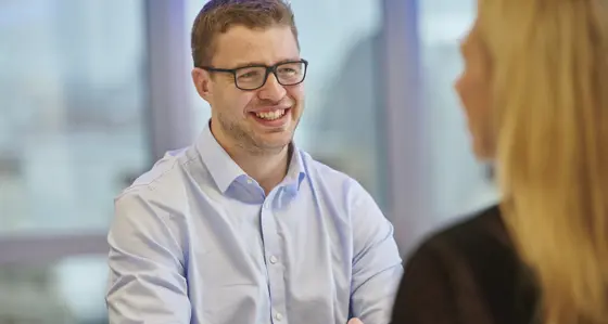 Two colleagues chatting and smiling