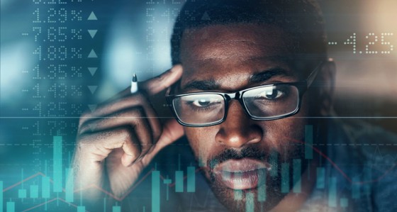 Man looking at graph showing ups and downs of stock market