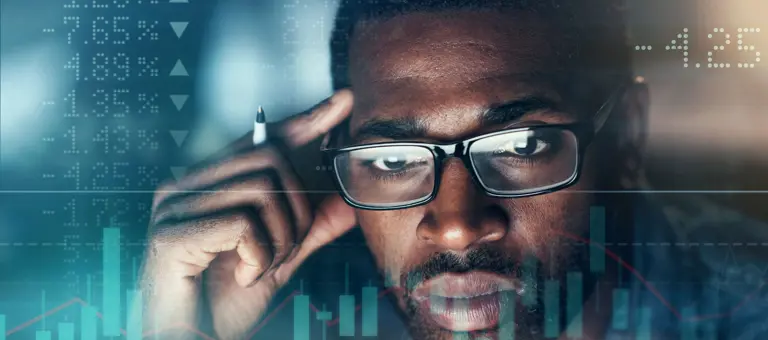 Man looking at graph showing ups and downs of stock market