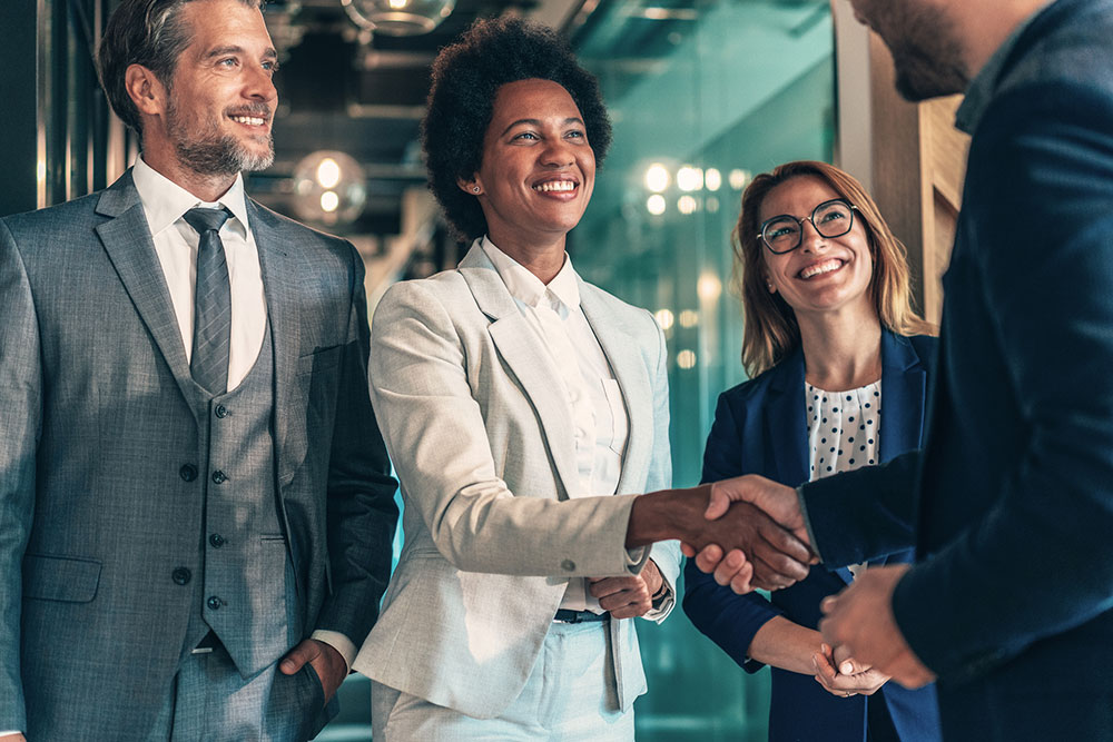 Group of business persons shaking hands in the office