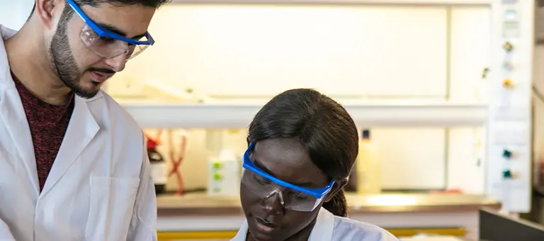 A man and a woman working in a laboratory