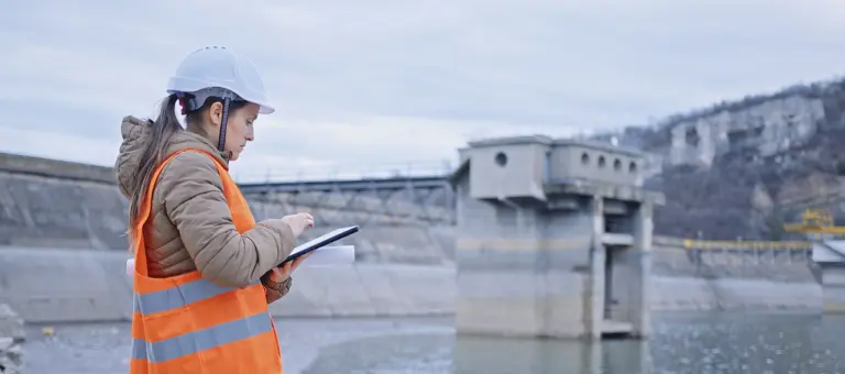 Woman inspecting a water facility