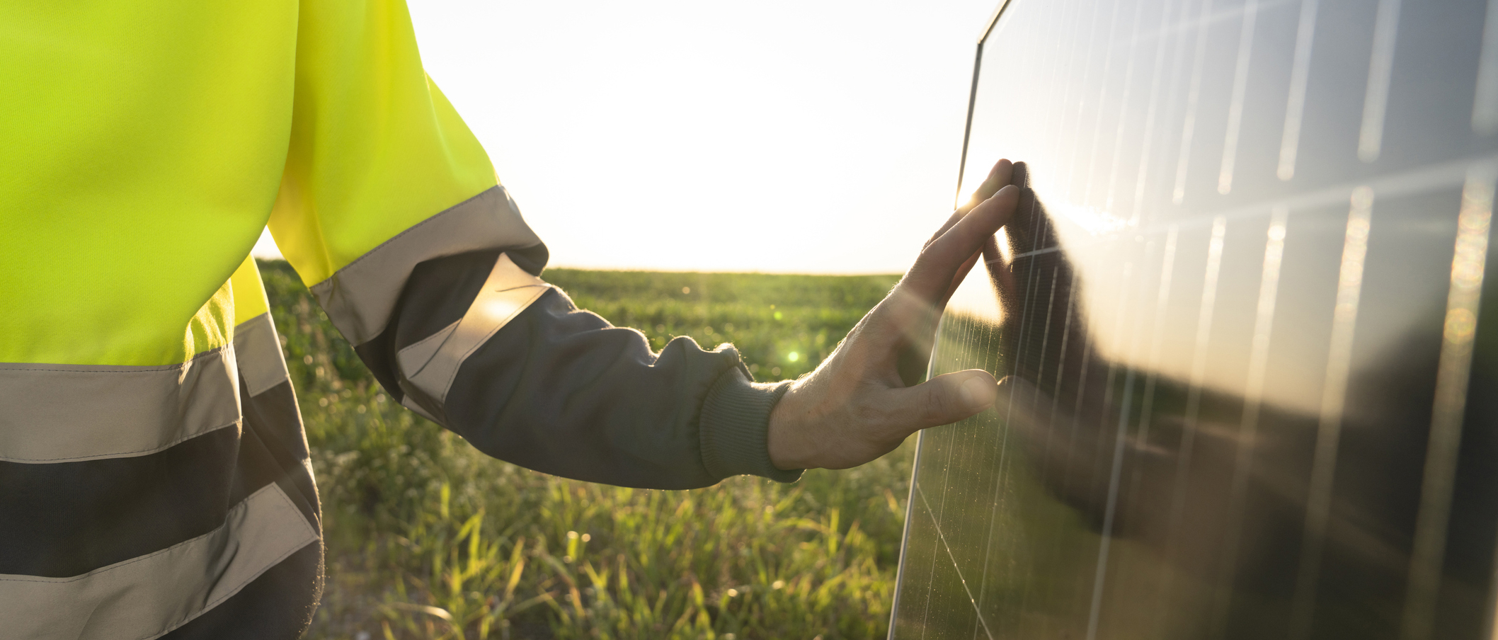 worker touching solar panel