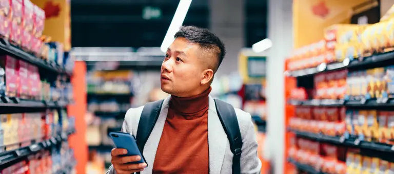 Man looking at shelves in a supermarket