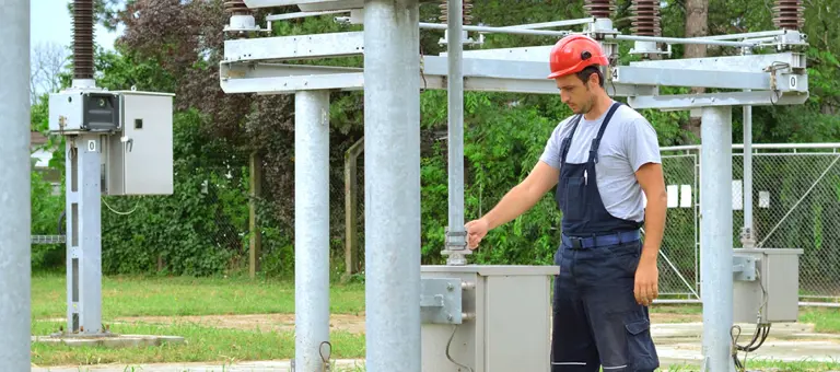 An engineer inspecting equipment in an electrical substation