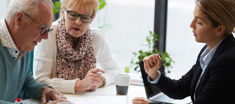 Middle aged couple going through a contract with an insurer