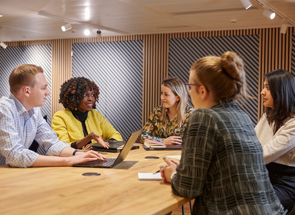 Group of people having a conversation in an office