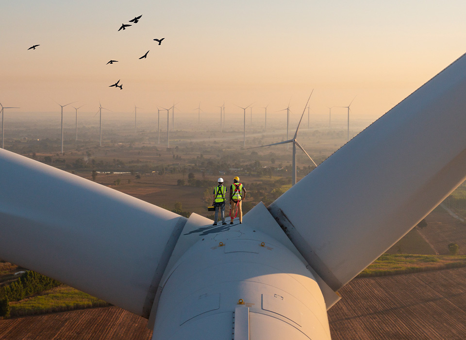 Two rope access technicians working on higher wind turbine blades