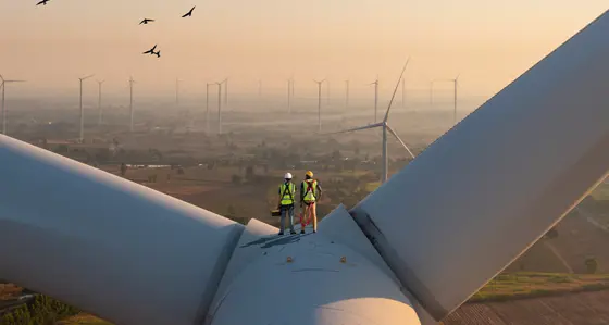Two rope access technicians working on higher wind turbine blades