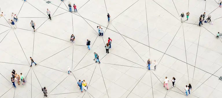An aerial view of people walking over a triangular-patterned surface