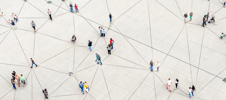 An aerial view of people walking over a triangular-patterned surface