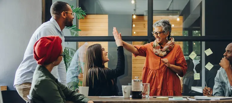 Two colleagues making a 'high five'