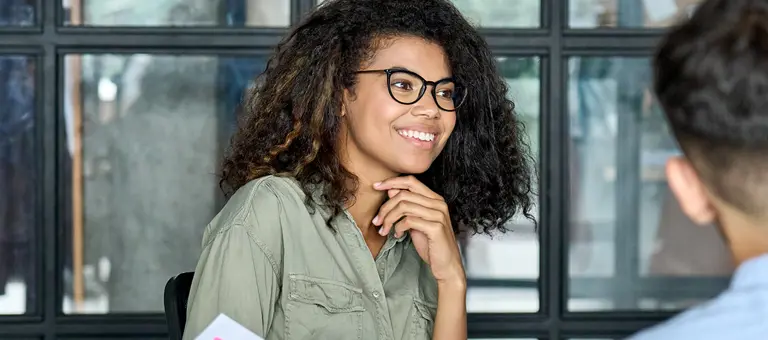 A smiling woman in a meeting