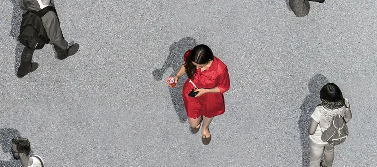 Woman walking among other people