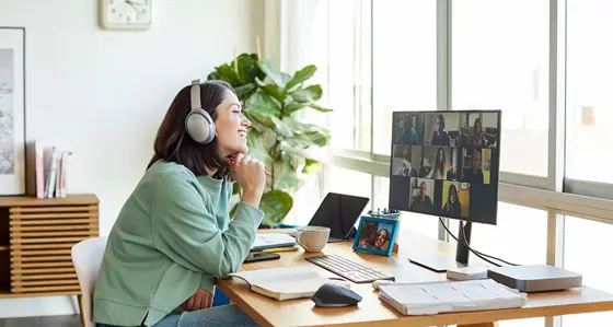 Smiling businesswoman discussing with colleagues through video call