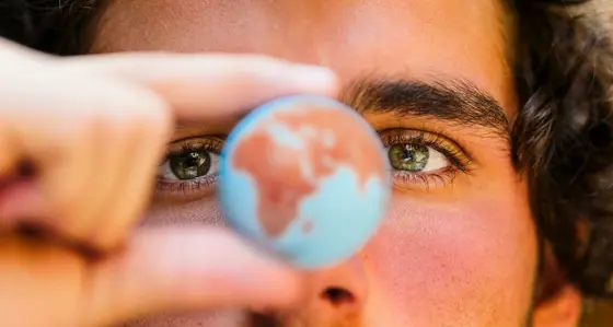 Close up view of a man holding a globe