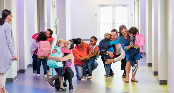 Parents and children in a school corridor