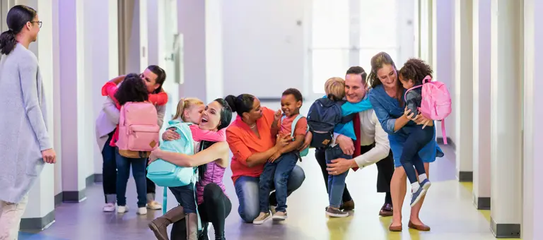 Parents and children in a school corridor