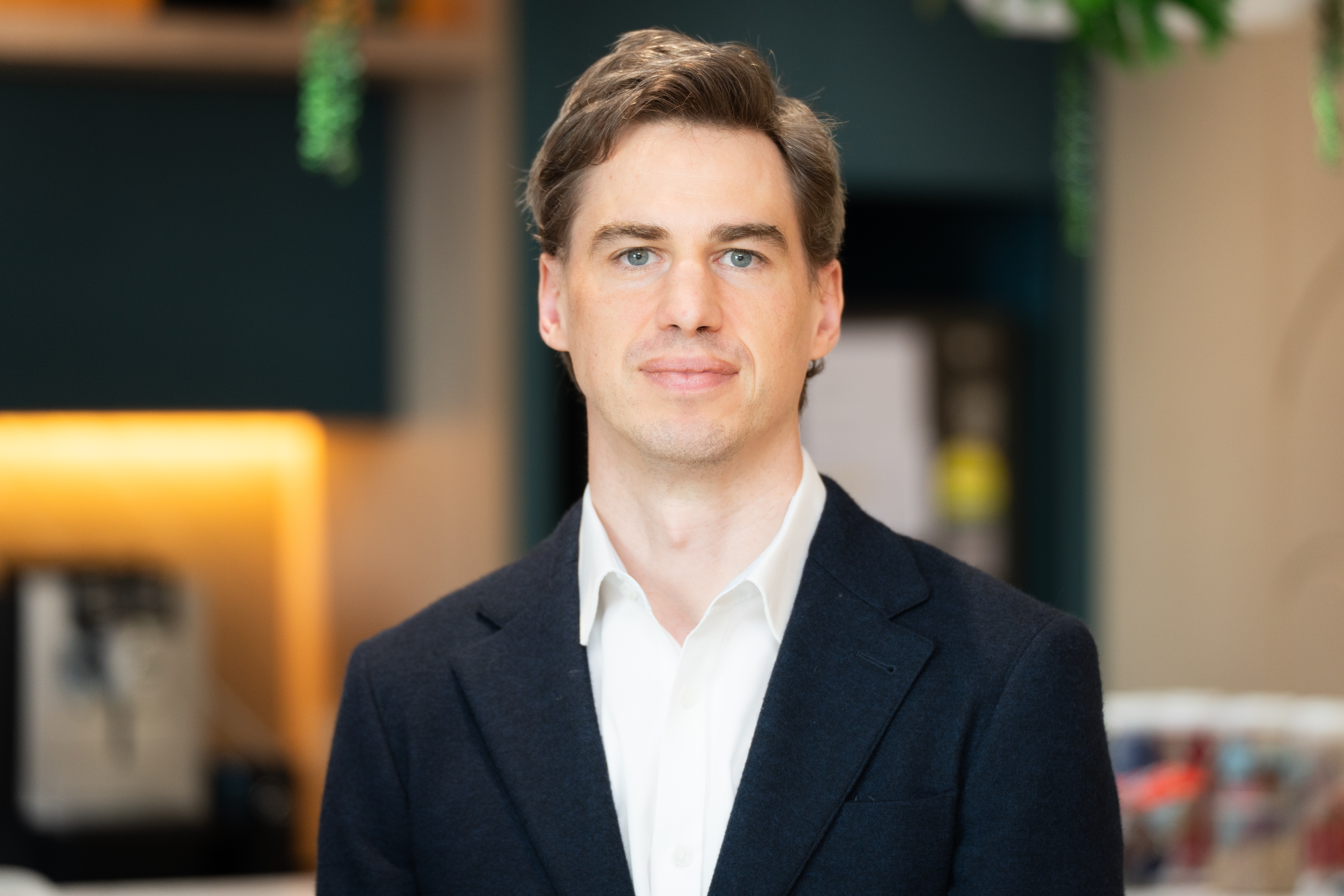 A professional headshot of Sam Porter