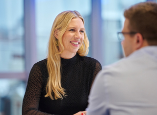 A smiling woman in a discussion