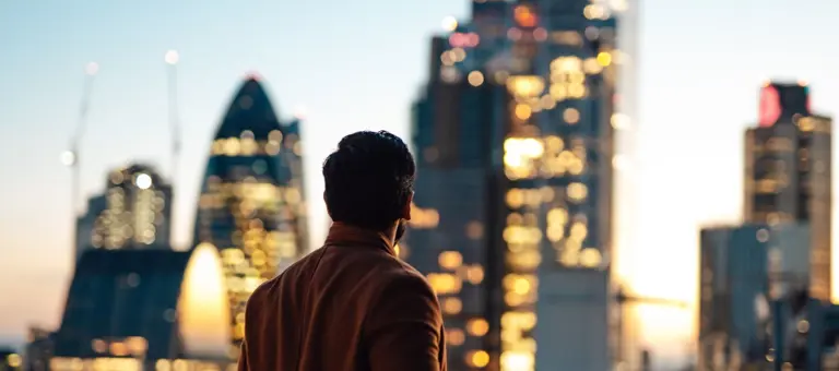 Man looking out at London skyline