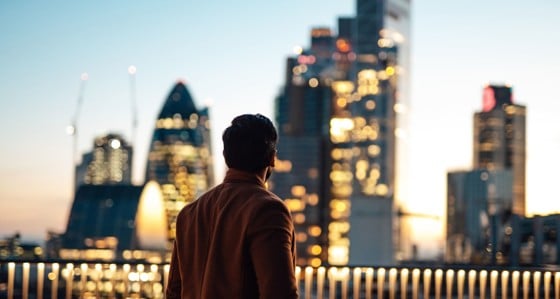 Man looking out at London skyline