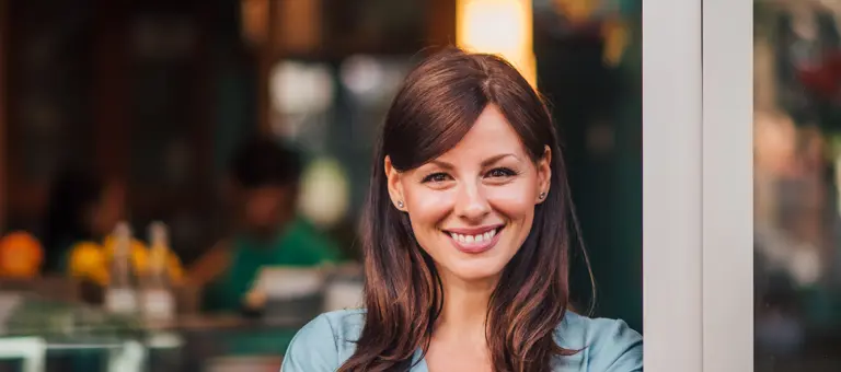 Waitress smiling outside a cafe