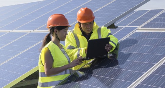 Two engineers working on solar panels