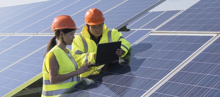 Two engineers working on solar panels