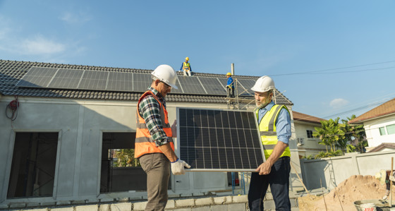 Two engineers installing a solar panel