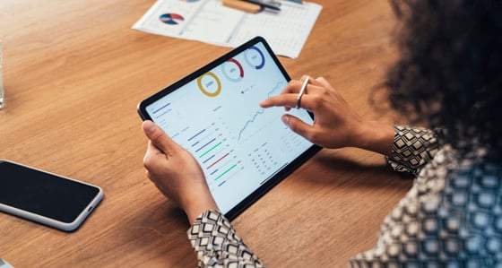 A woman viewing data on a tablet