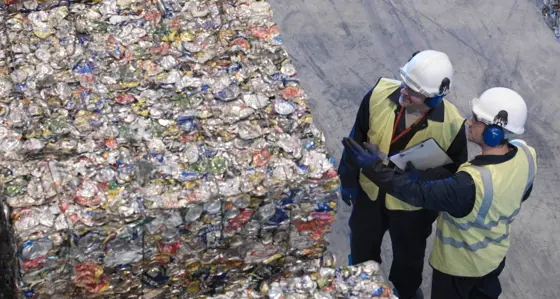 Workers With Bales Of Tin Cans