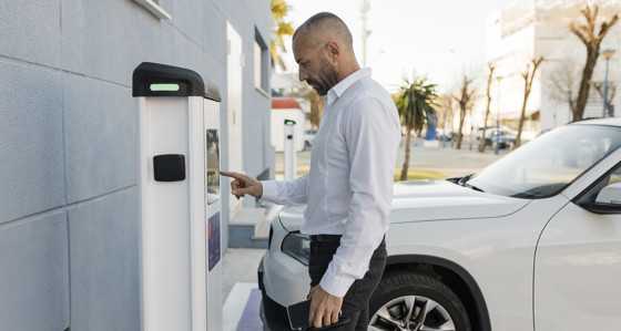 Man using an EV charger