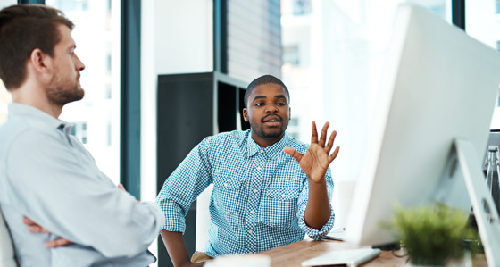 Two people looking at a computer