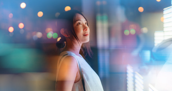 Young woman looking at futuristic digital display