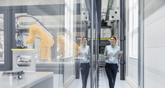 A woman with a clipboard in a manufacturing plant