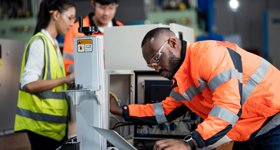 Workers inspecting a machine