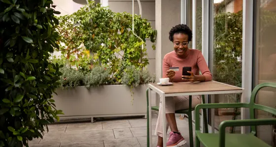 Woman pays for coffee on her phone