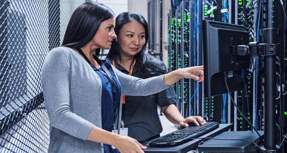 Women looking at a screen in a data centre