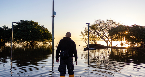 Man looking at a flooded landscape