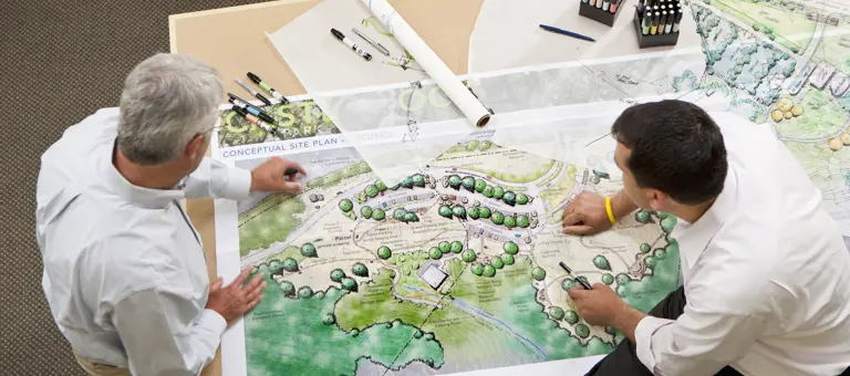 Two men looking at land plans