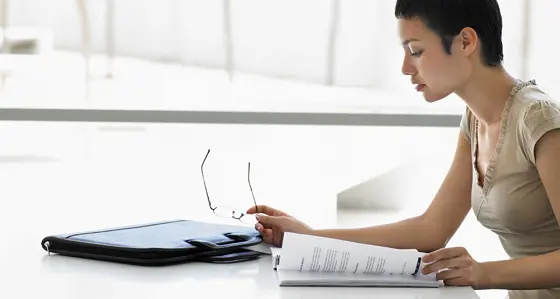 A woman reading a report