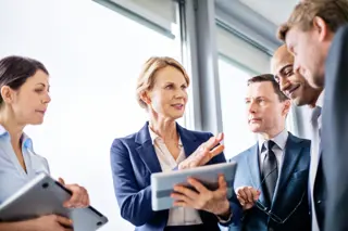 Five work colleagues in discussion