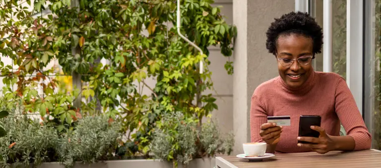 Woman paying for coffee on her phone